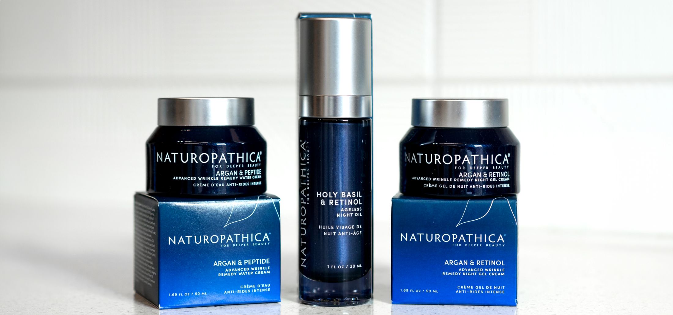 Naturopathica skincare products on a white surface.