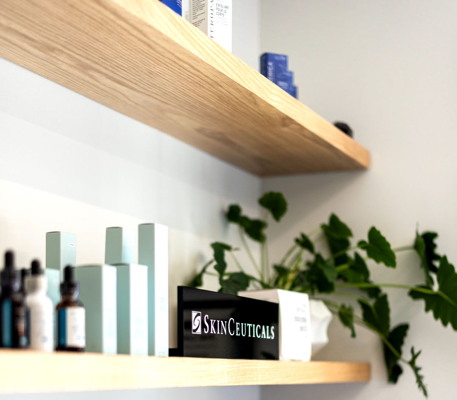 SkinCeuticals products displayed on wooden shelves.